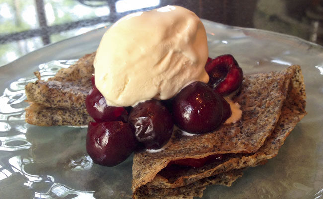Buckwheat crepes filled with sour cherry jam and topped with Bing cherries and ice cream.