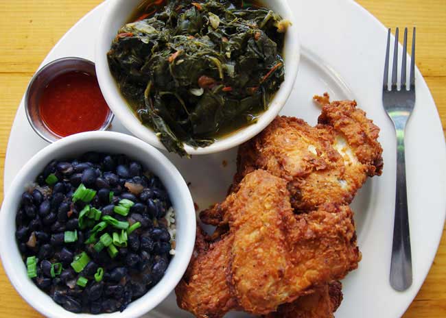 Chicken wings with rice, beans, and collards at Breaking Bread.